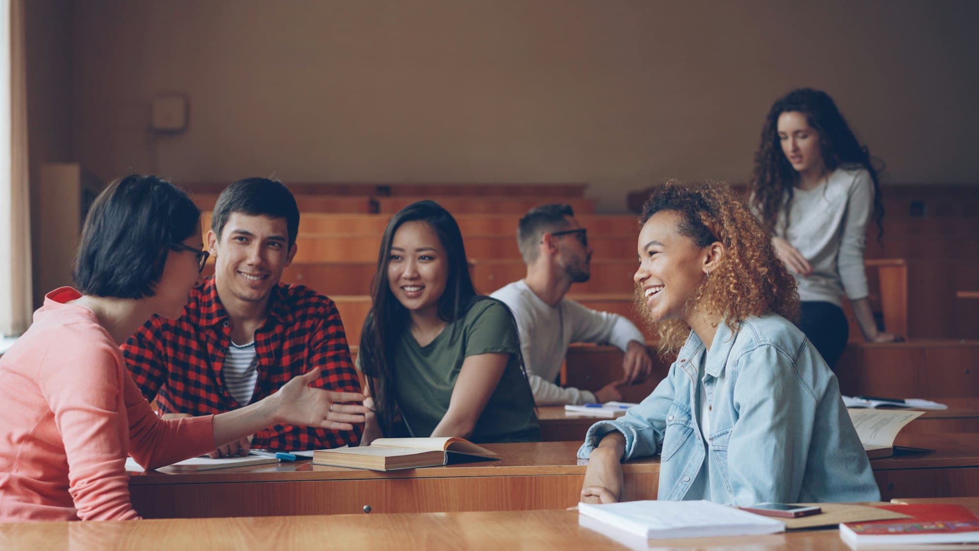 Students chatting in a lecture hall during a break
